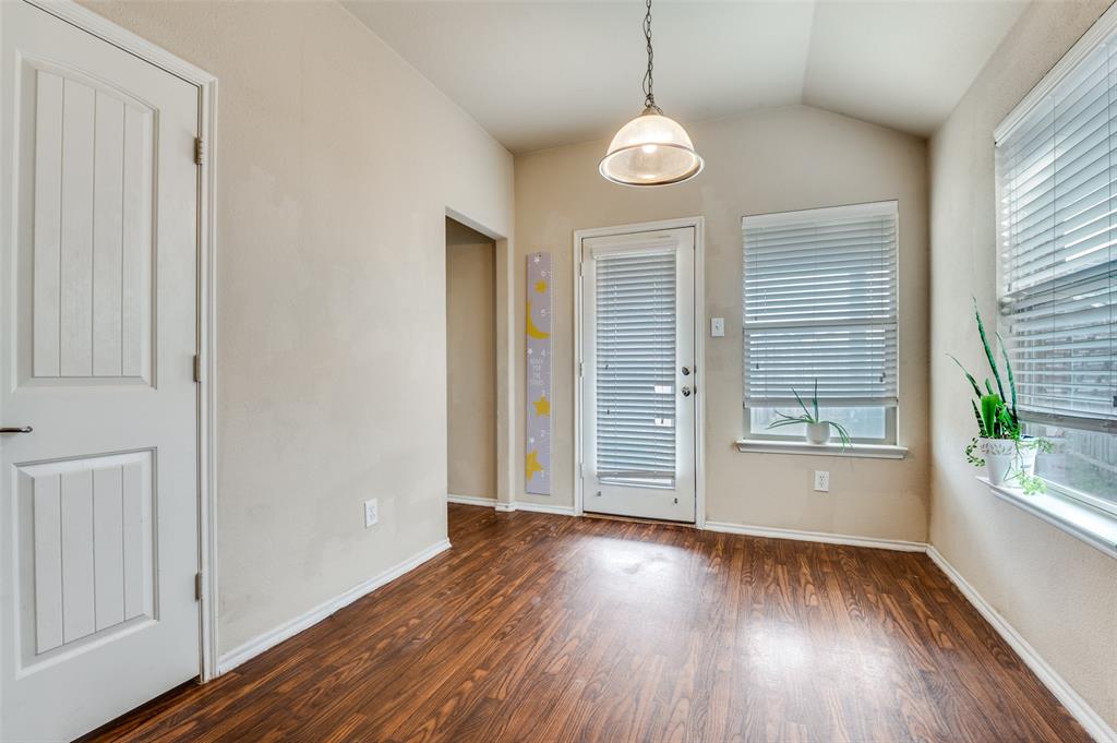 4040 Golden Rod Drive Forney, TX 75126 - Photo 13 of 25 an empty room with wooden floor and windows
