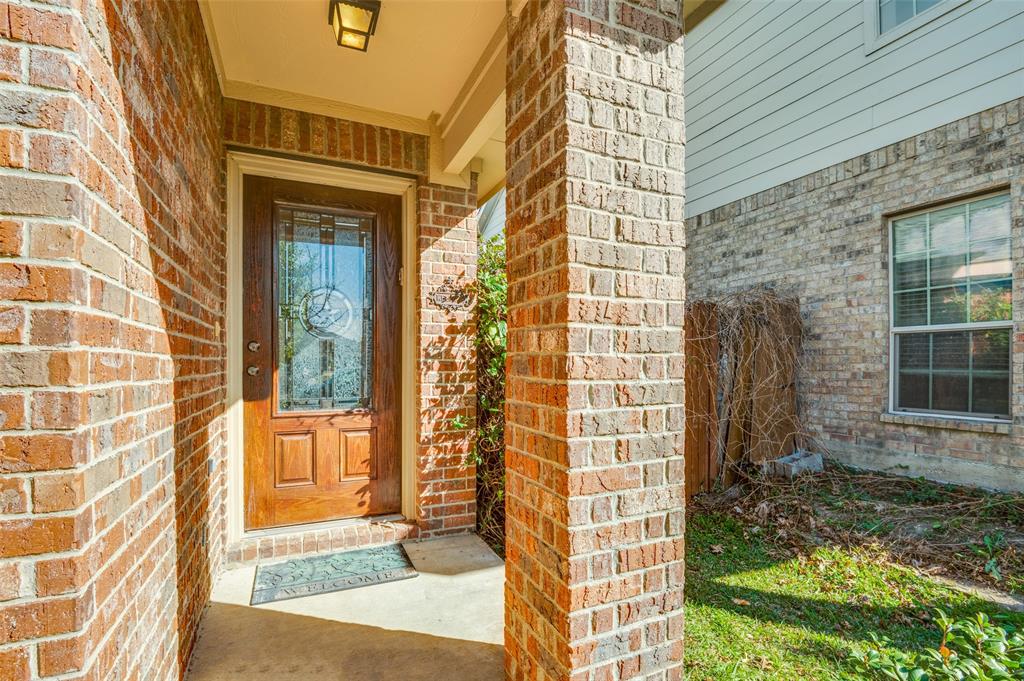 4040 Golden Rod Drive Forney, TX 75126 - Photo 4 of 25 a view of a brick house with a floor to ceiling window and front of a house