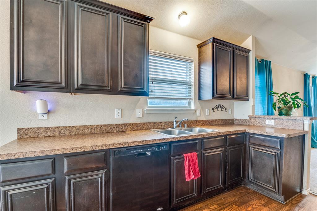 4040 Golden Rod Drive Forney, TX 75126 - Photo 8 of 25 a kitchen with stainless steel appliances granite countertop a sink stove and cabinets