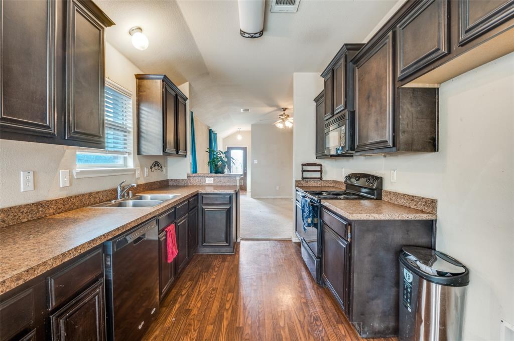 4040 Golden Rod Drive Forney, TX 75126 - Photo 9 of 25 a kitchen with a sink stove and cabinets