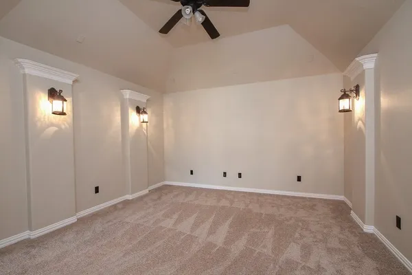 a view of a livingroom with a ceiling fan and window