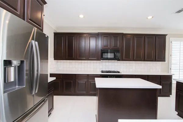 a kitchen with a refrigerator a sink and a refrigerator