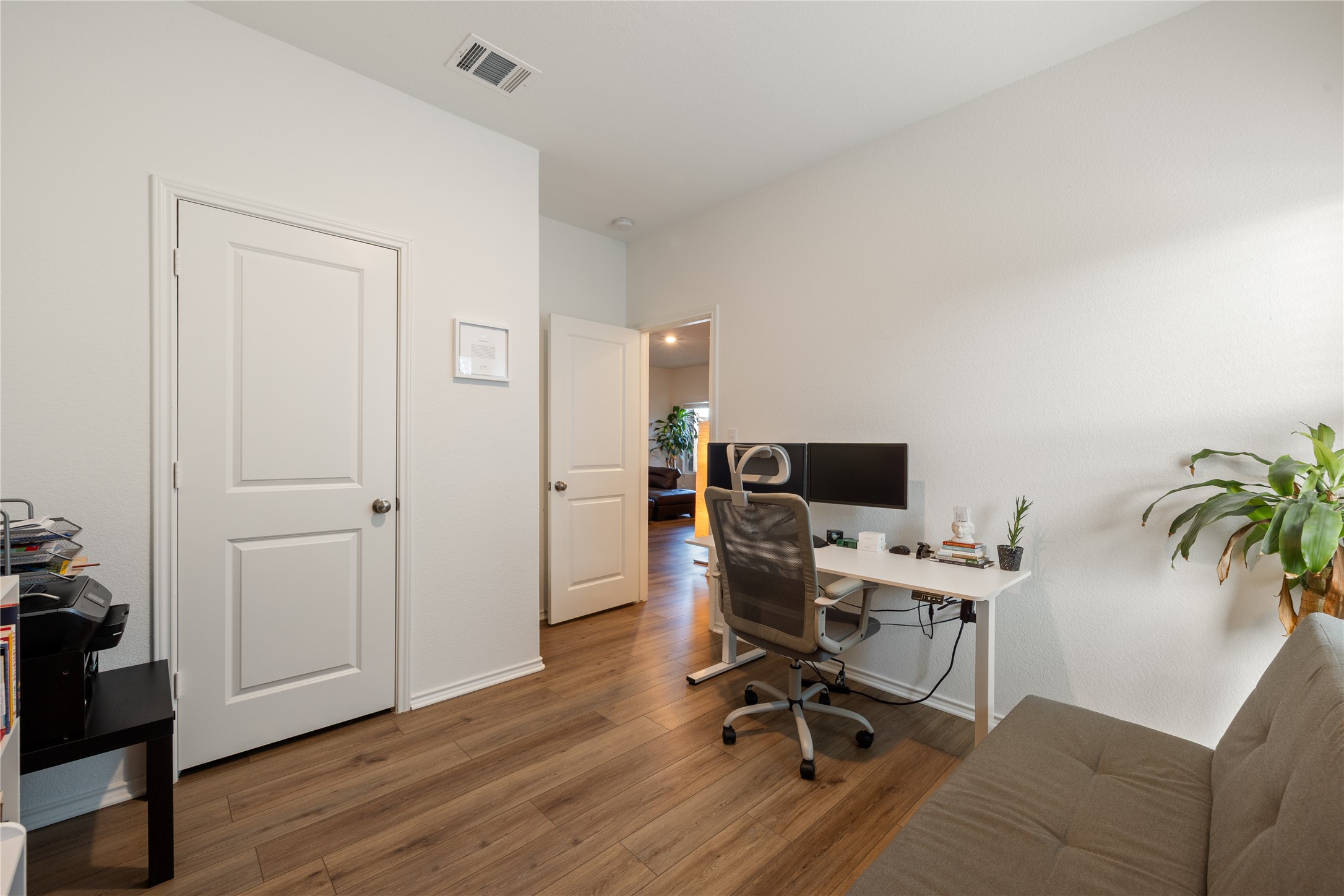 14404 Berning Road Manor, TX 78653 - Photo 33 of 38 Well-lit room featuring warm wood flooring and an open doorway.