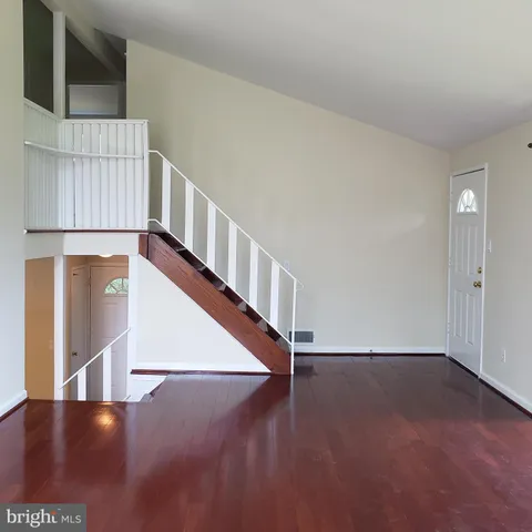 a view of an entryway with wooden floor