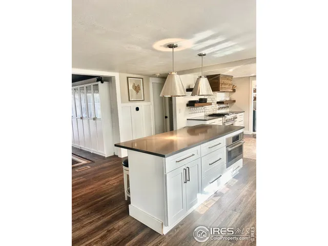 a kitchen with stainless steel appliances granite countertop a stove and a refrigerator