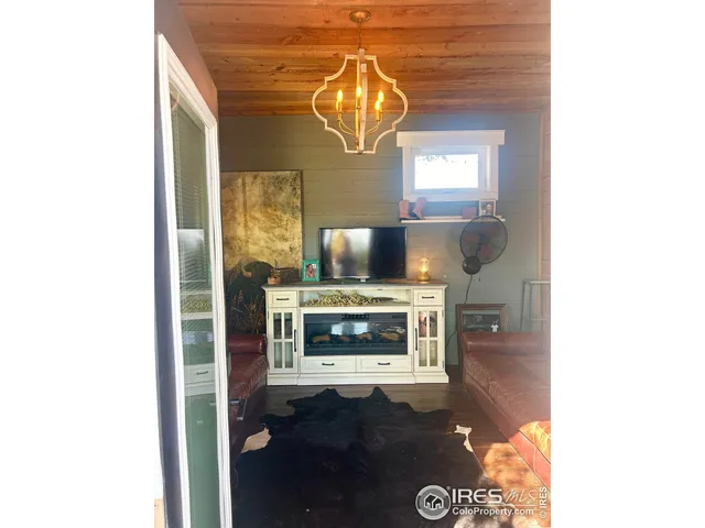 a living room with a fireplace and a chandelier
