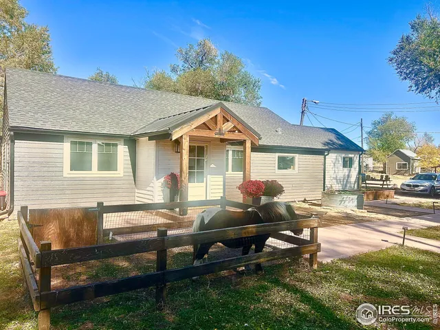 a backyard of a house with barbeque oven table and chairs