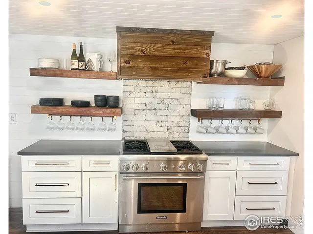 a stove top oven sitting inside of a kitchen