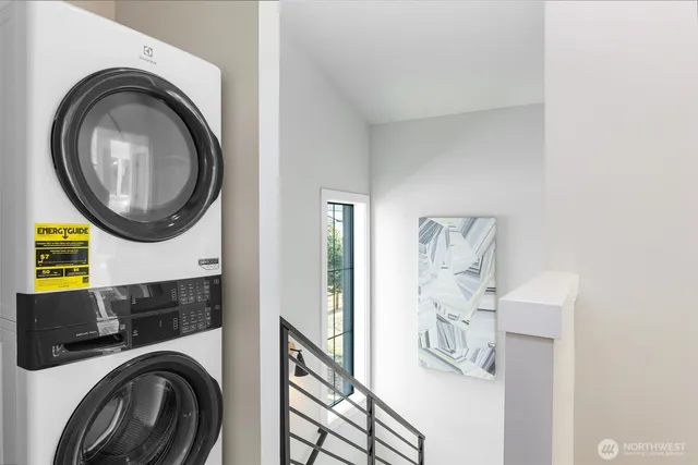 a view of a bedroom with washer and dryer