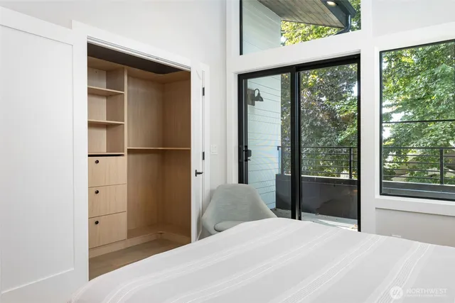 a bedroom with a bed and a large window