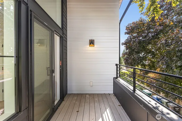 a view of balcony with wooden floor and fence