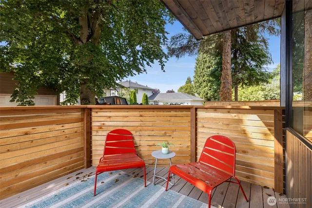 a view of sitting area with chairs and wooden fence