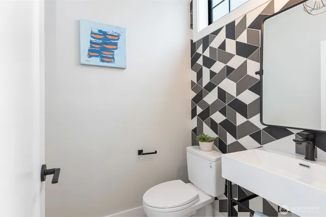 a white toilet sitting next to a bathroom sink