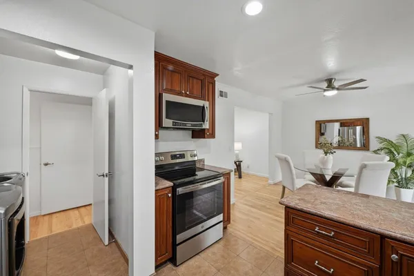a kitchen with granite countertop a stove and a sink