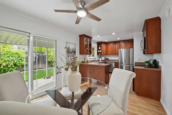 a living room with stainless steel appliances kitchen island furniture and a large window