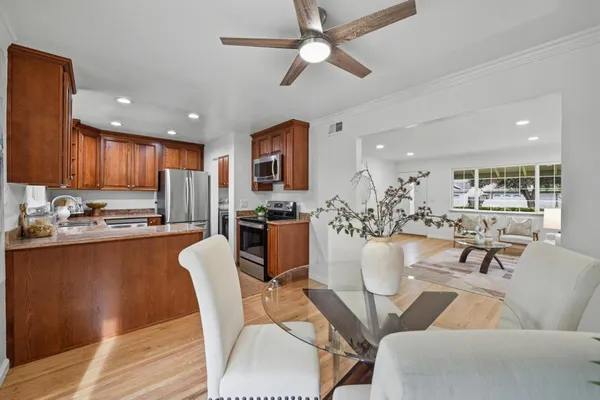 a living room with stainless steel appliances kitchen island granite countertop furniture and a view of kitchen