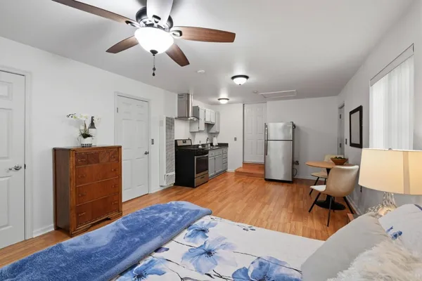 a kitchen with stainless steel appliances kitchen island granite countertop a refrigerator and a stove top oven