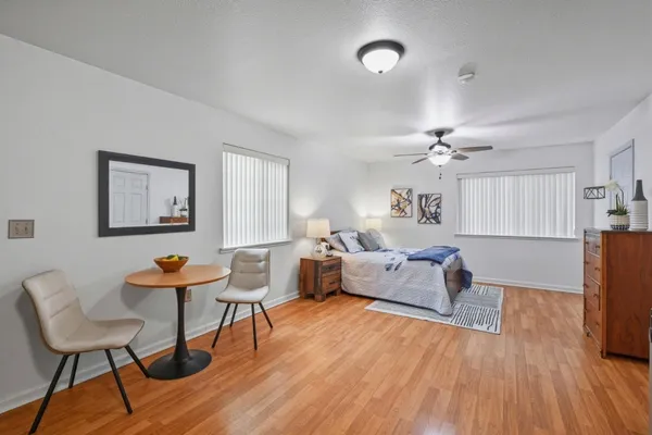 a living room with furniture and wooden floor