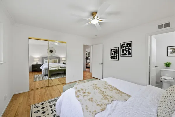 a bedroom with a bed and a chandelier