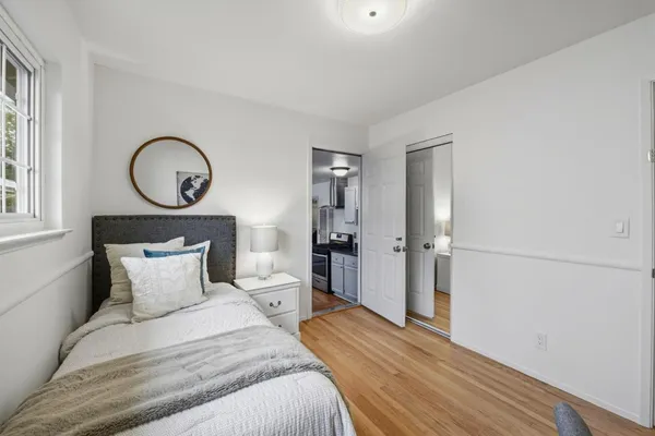 a bedroom with a bed and a large window