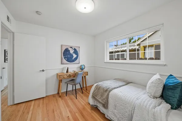 a bedroom with a bed and a table in it