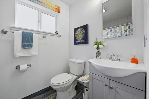 a bathroom with a sink mirror and toilet