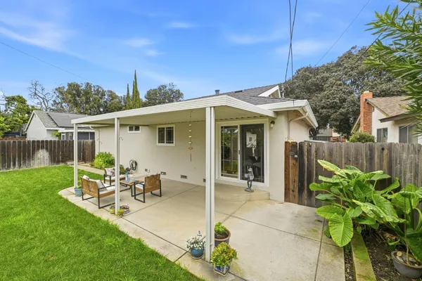 a front view of a house with a garden and yard