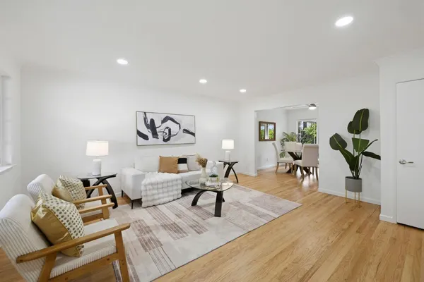 a living room with furniture and wooden floor