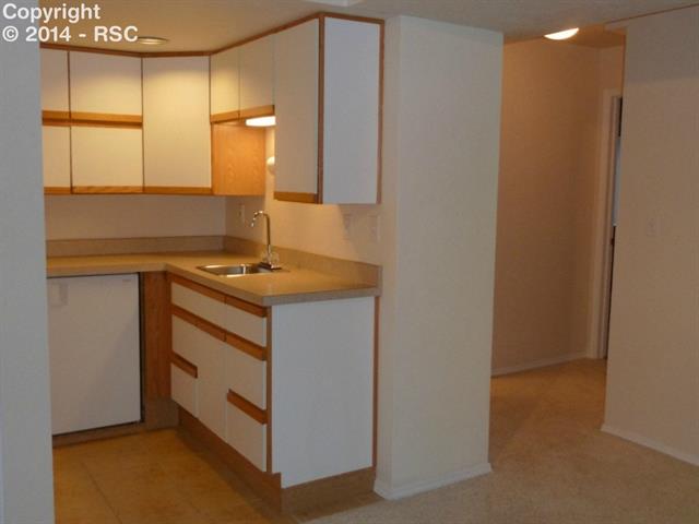 7625 Julynn Road Colorado Springs, CO 80919 - Photo 25 of 34 Wet bar with refrigerator