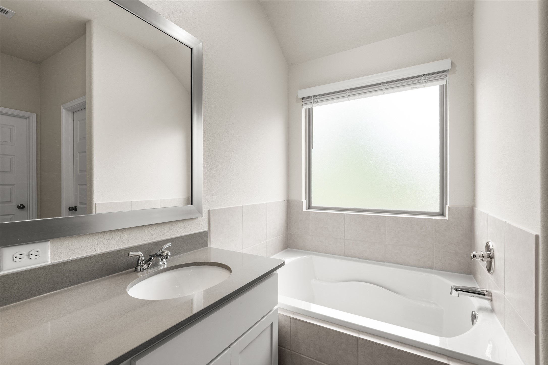 4001 Baja Lane Houston, TX 77045 - Photo 18 of 27 Positioned beneath a large privacy window, the soaking tub creates a bright and inviting space to unwind while allowing natural light to fill the room throughout the day.