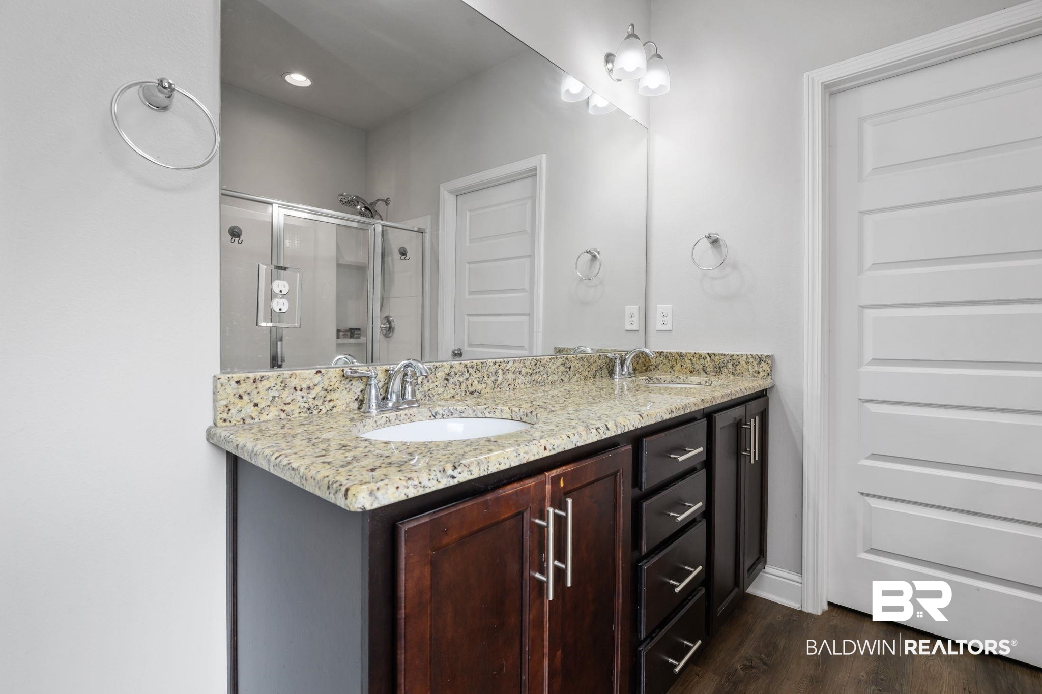 12693 Waxwing Avenue Daphne, AL 36527 - Photo 31 of 43 Full bathroom featuring double vanity, a shower stall, and dark wood-type flooring