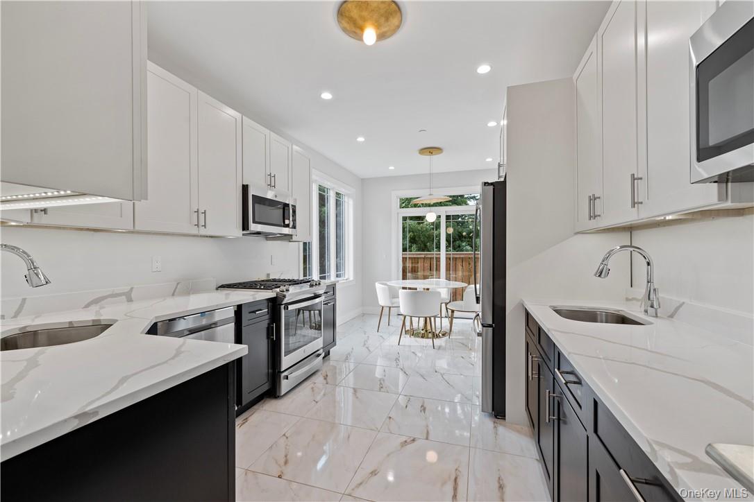 16 Dessau Circle Spring Valley, NY 10977 - Photo 15 of 32 a kitchen with granite countertop a sink stove and cabinets