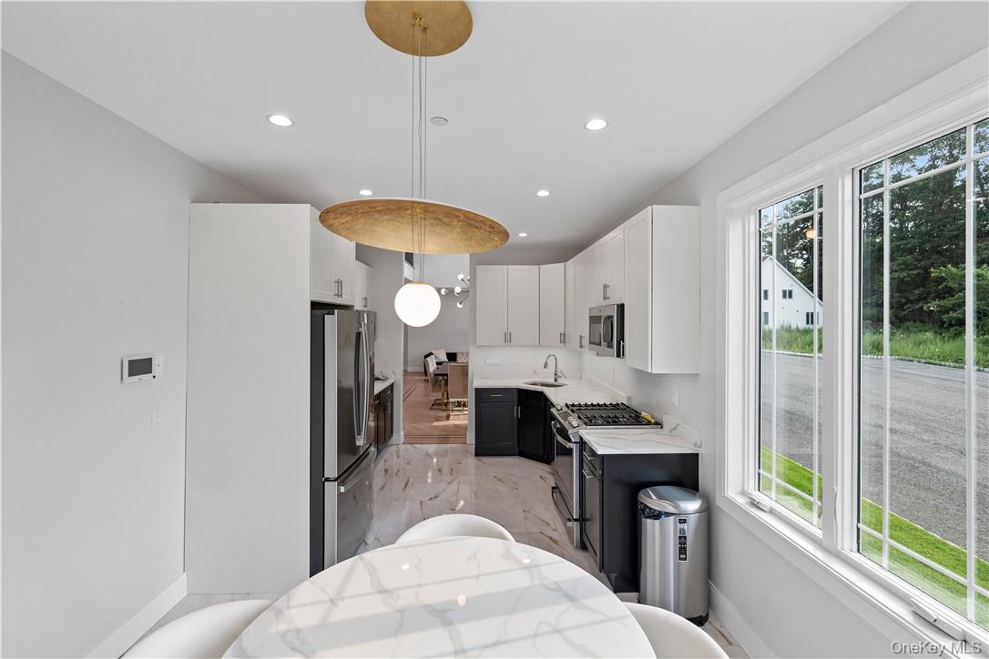 16 Dessau Circle Spring Valley, NY 10977 - Photo 17 of 32 a kitchen with stainless steel appliances kitchen island granite countertop a refrigerator a sink and a stove
