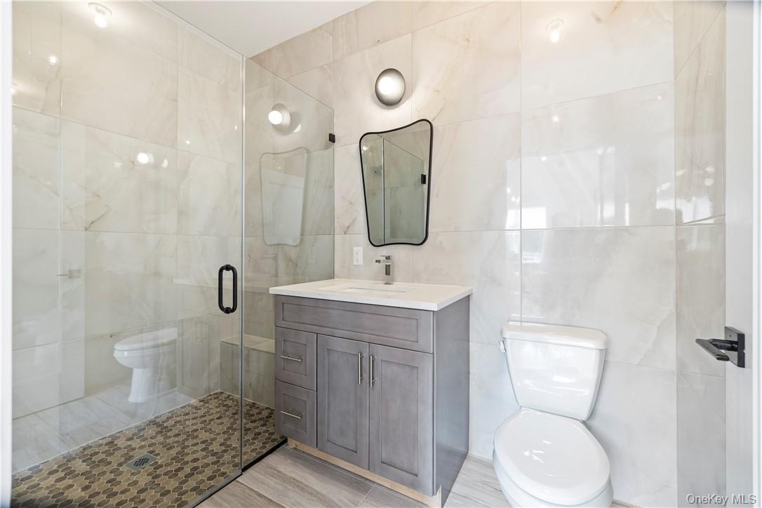 16 Dessau Circle Spring Valley, NY 10977 - Photo 19 of 32 a bathroom with a toilet sink and mirror