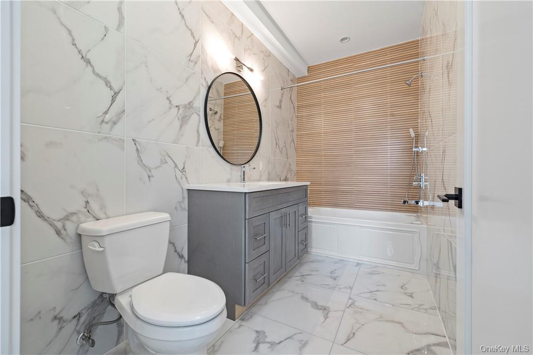 16 Dessau Circle Spring Valley, NY 10977 - Photo 23 of 32 a bathroom with a toilet a sink and a bathtub