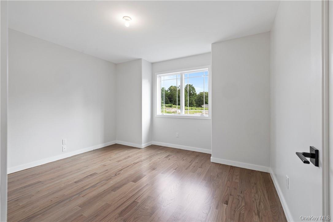 16 Dessau Circle Spring Valley, NY 10977 - Photo 25 of 32 an empty room with wooden floor and windows