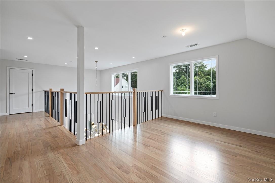 16 Dessau Circle Spring Valley, NY 10977 - Photo 27 of 32 an empty room with wooden floor and windows