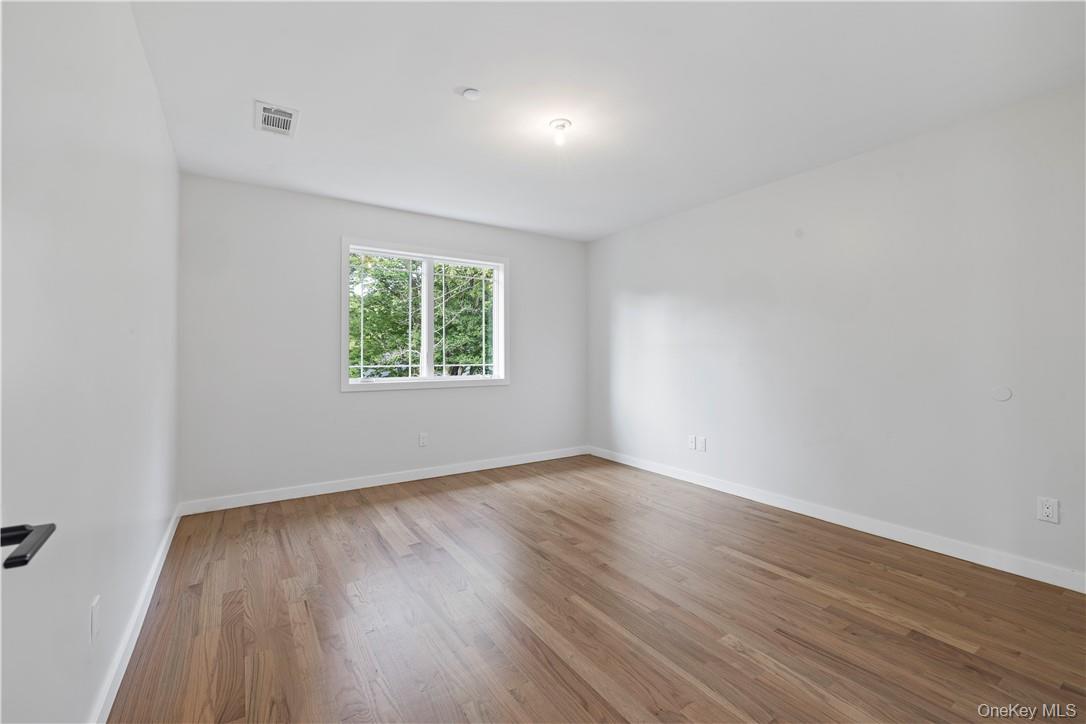 16 Dessau Circle Spring Valley, NY 10977 - Photo 28 of 32 wooden floor in an empty room with a window
