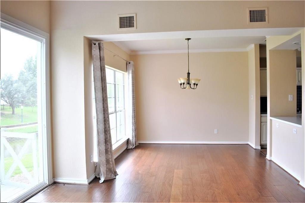 812 Canal Street Irving, TX 75063 - Photo 3 of 11 a view of a hallway with wooden floor and windows