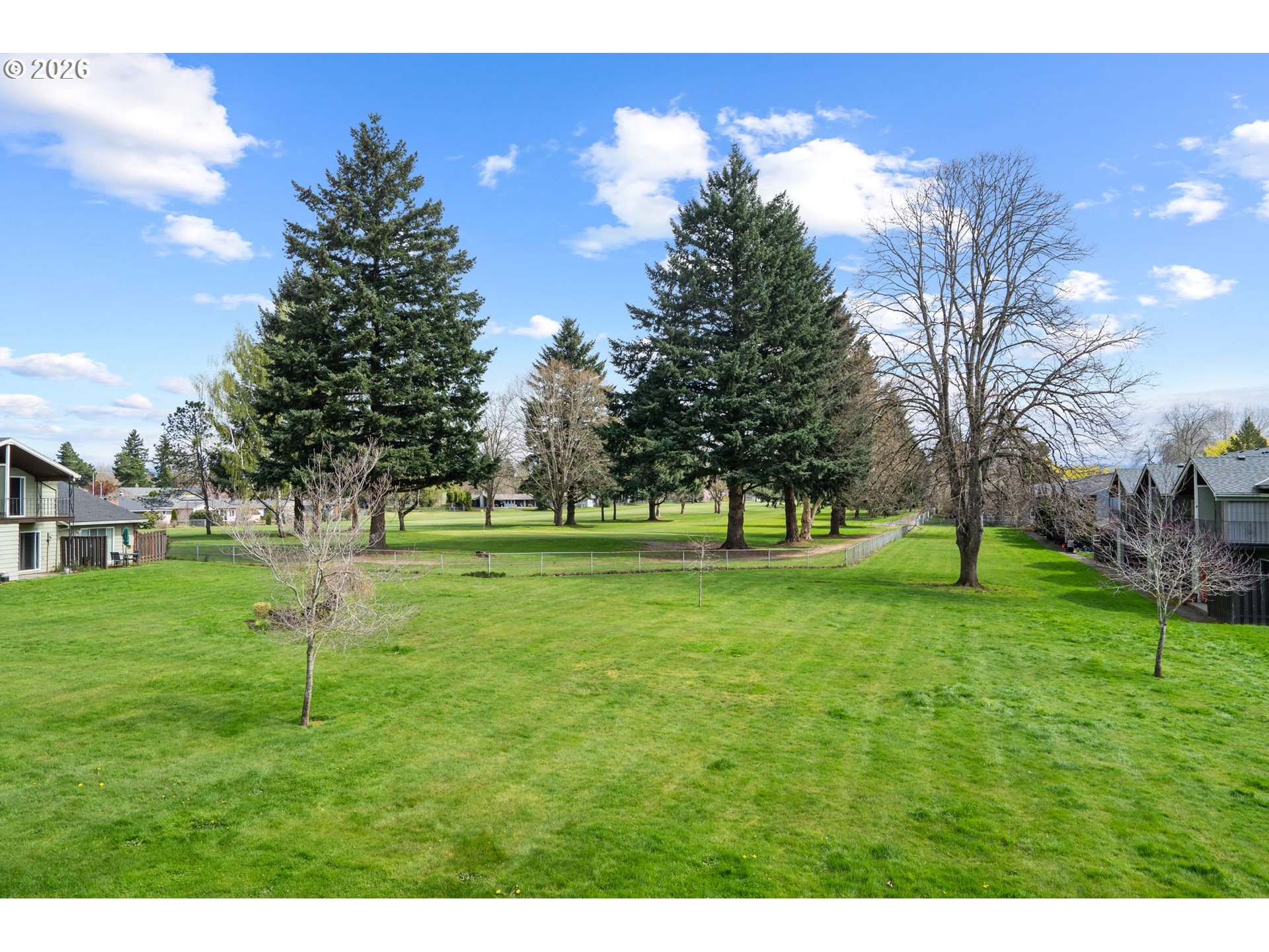 1773 Northeast 19th Street Gresham, OR 97030 - Photo 2 of 18 a grassy field with trees in the background