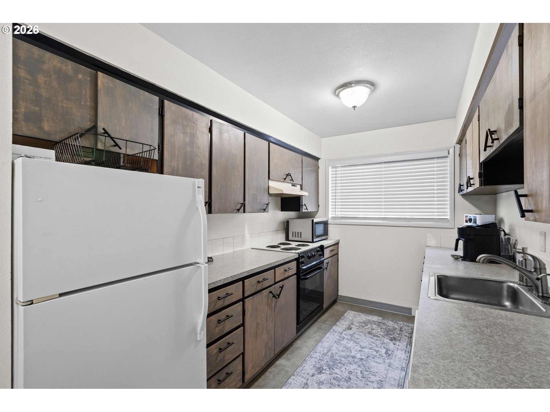 1773 Northeast 19th Street Gresham, OR 97030 - Photo 4 of 18 a kitchen with stainless steel appliances granite countertop a refrigerator sink stove and cabinets