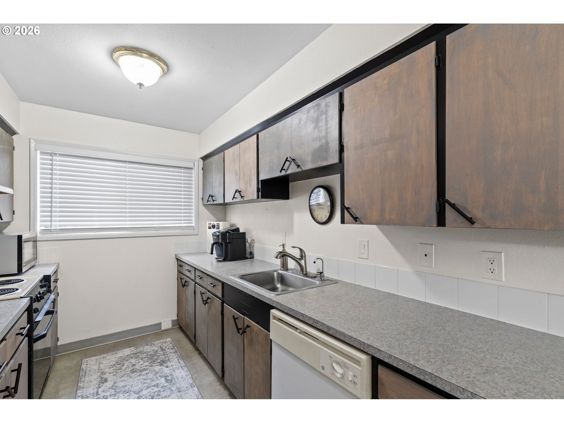 1773 Northeast 19th Street Gresham, OR 97030 - Photo 5 of 18 a kitchen with a sink a stove and cabinets