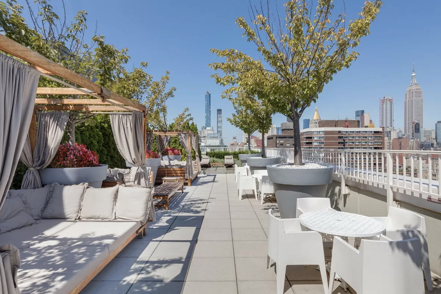 340 East 23rd Street, Unit 7H Manhattan, NY 10010 - Photo 4 of 10 a view of a patio with couches table and chairs and potted plants