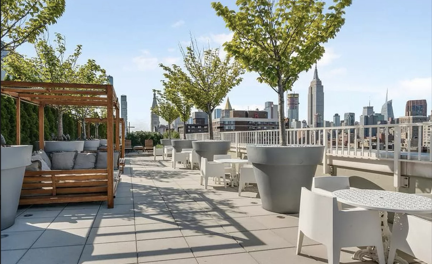 340 East 23rd Street, Unit 7H Manhattan, NY 10010 - Photo 5 of 10 a view of a patio with couches and a potted plant on a table and chairs