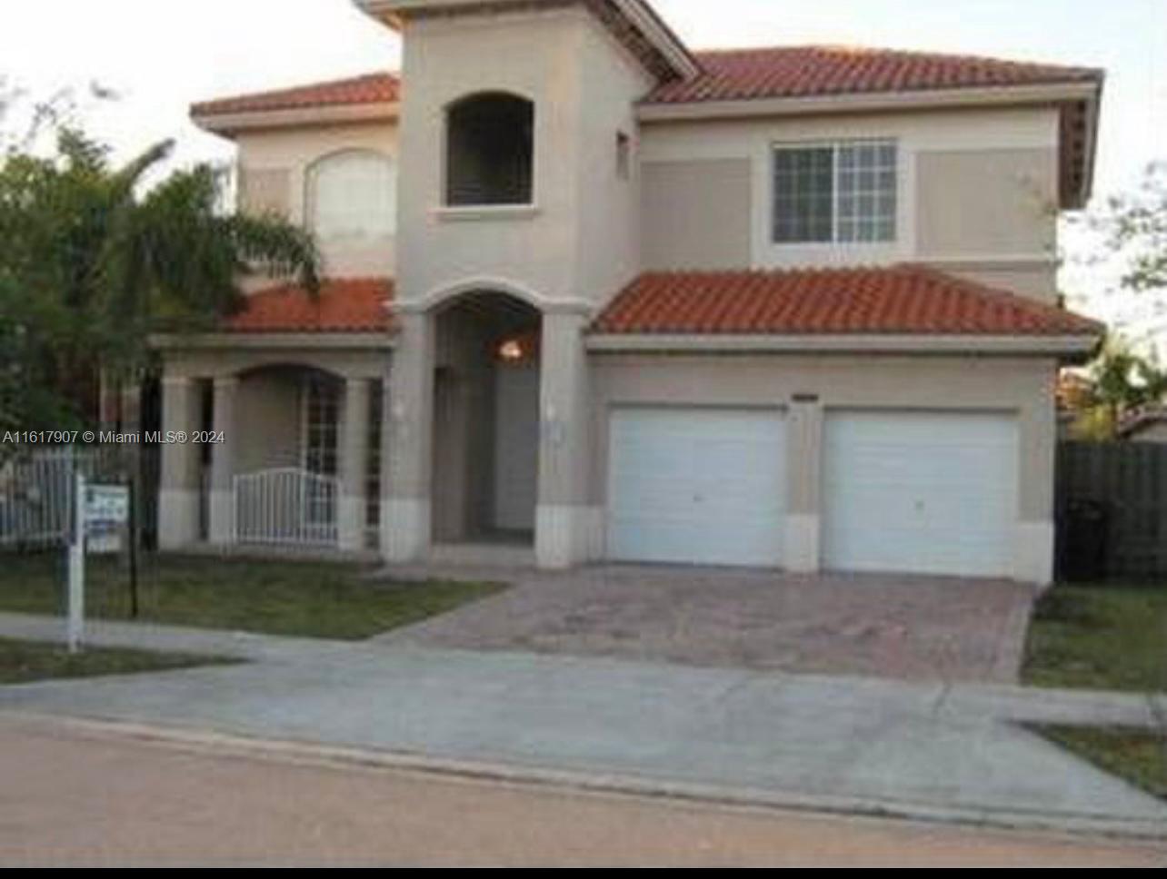 15259 Southwest 23rd Lane Miami, FL 33185 - Photo 1 of 10 a front view of a house with a yard and garage