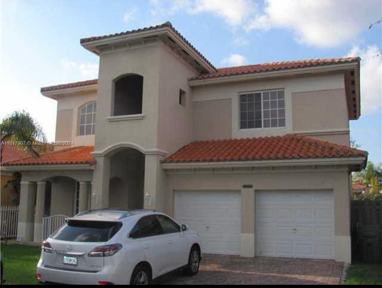 15259 Southwest 23rd Lane Miami, FL 33185 - Photo 2 of 10 a front view of a house with parking