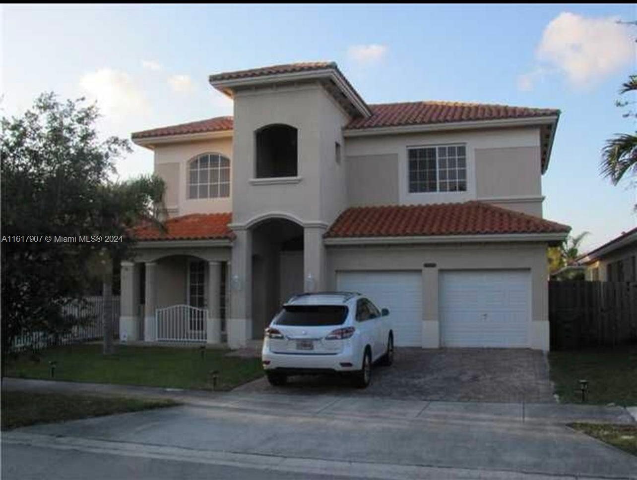 15259 Southwest 23rd Lane Miami, FL 33185 - Photo 3 of 10 a front view of a house with a yard