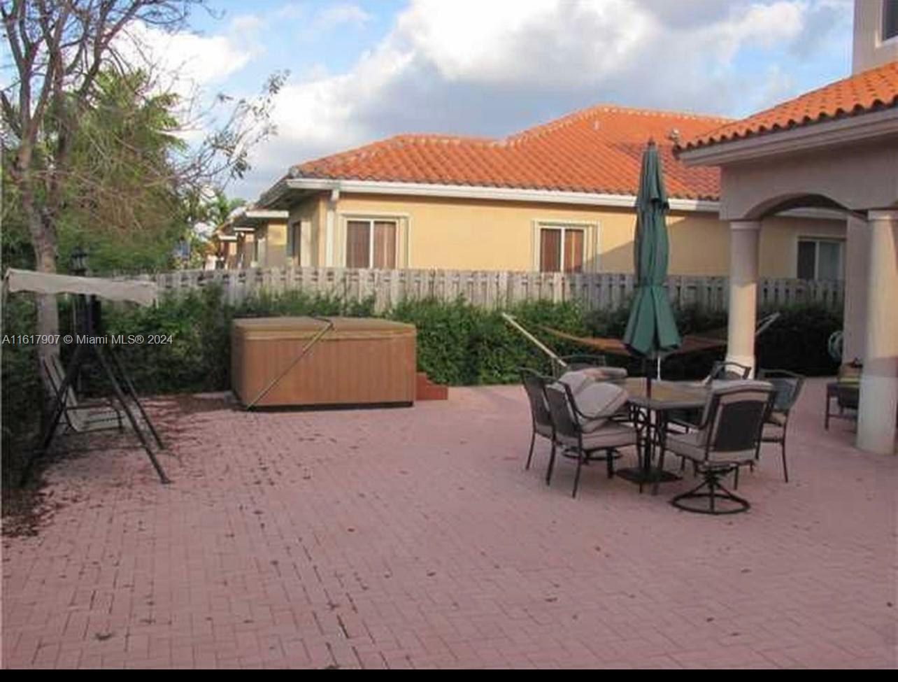 15259 Southwest 23rd Lane Miami, FL 33185 - Photo 7 of 10 a view of a house with backyard sitting area and garden