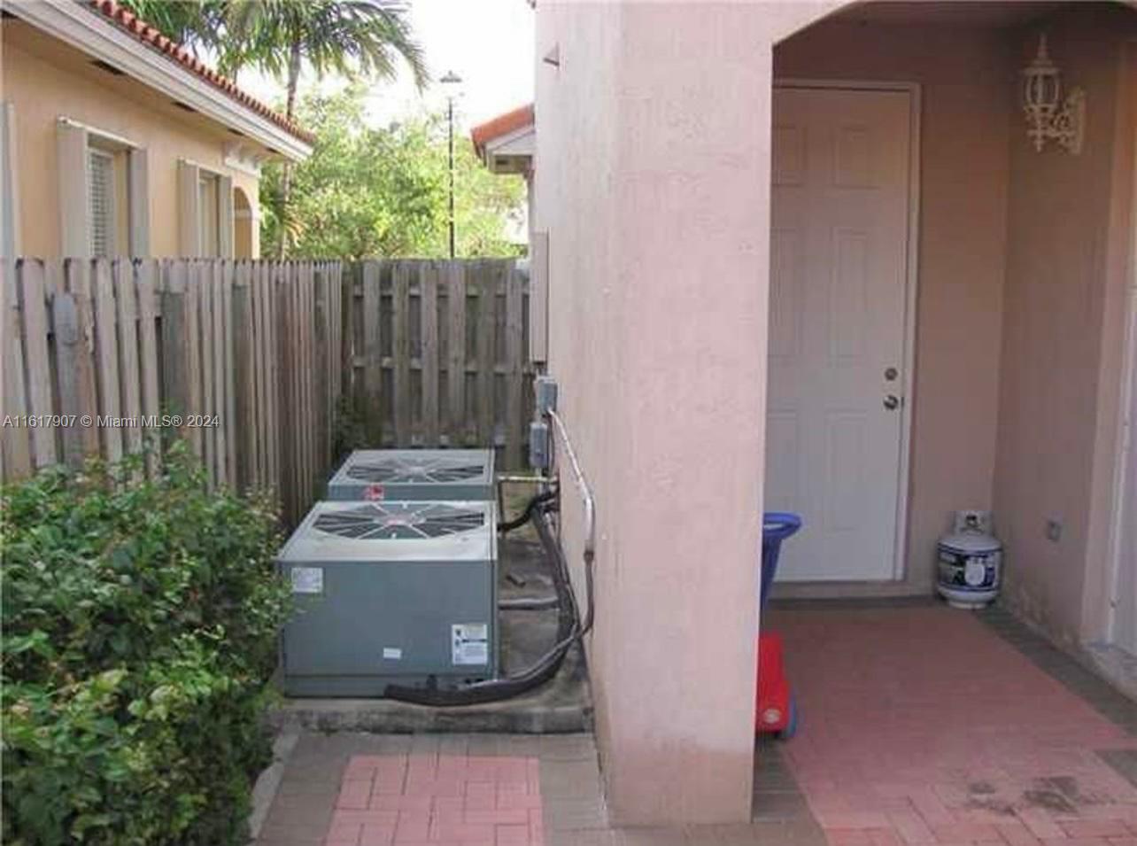 15259 Southwest 23rd Lane Miami, FL 33185 - Photo 9 of 10 a view of a door and chair in front of house