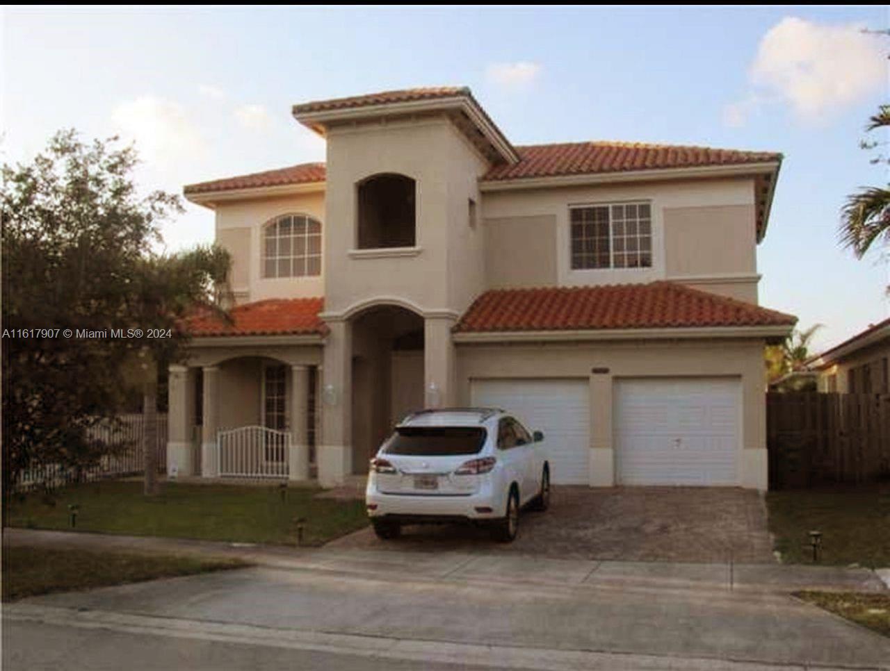15259 Southwest 23rd Lane Miami, FL 33185 - Photo 10 of 10 a front view of a house with a parking space